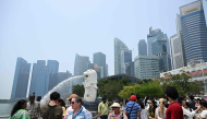People gather at Marina bay waterfront in Merlion park in Singapore on September 29, 2026. (Photo by Roslan Rahman / AFP)