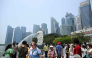 People gather at Marina bay waterfront in Merlion park in Singapore on September 29, 2026. (Photo by Roslan Rahman / AFP)