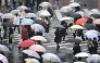 (Files) Pedestrians with umbrellas walk on a crossing as rain falls in Tokyo's Shibuya district on September 20, 2026. (Photo by Rie Kikuchi / AFP)