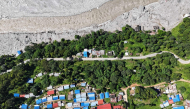 An aerial view shows damaged houses covered in sludge in the aftermath of the August 26 flash flood, at Betrawati Bazaar in Nepal's Rasuwa district on September 28, 2026.  (Photo by PRAKASH MATHEMA / AFP)