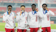 Qatar’s 4x400m relay quartet of Ammar Ibrahim, Bassem Hemeida, Youssef Djibrine and Ismail Abakar celebrate on the podium.