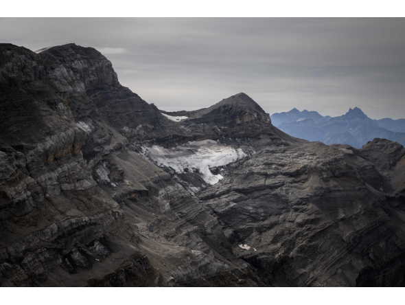 This photograph taken in western Switzerland on September 24, 2026 shows the remains of the now tiny Mauvais glacier, above Les Diablerets. The Swiss Glacier Monitoring Network (GLAMOS) will release its annual report on the state of Swiss glaciers on October 1, 2026. (Photo by Fabrice COFFRINI / AFP)