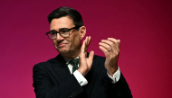 Britain's Prime Minister Andy Burnham applauds on the final day of the annual Labour Party conference in Liverpool, north-west England, on September 30, 2026. (Photo by Paul ELLIS / AFP)