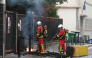 Firefighters extinguish a fire at the entrance of the Leonard de Vinci secondary school following a blockading action by protesting students, in Paris on October 2, 2026. (Photo by Thomas SAMSON / AFP)