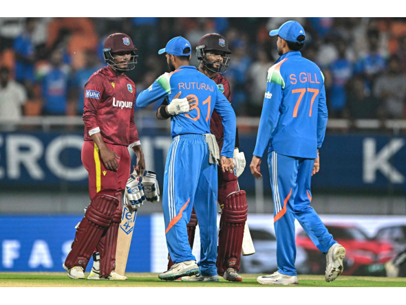 West Indies' captain Shai Hope (2R) and Gudakesh Motie (L) greet India's Ruturaj Gaikwad (2L) and captain Shubman Gill at the end of the third one-day international (ODI) cricket match between India and West Indies at the Maharaja Yadavindra Singh International Cricket Stadium on the outskirts of Chandigarh on October 3, 2026. (Photo by Sajjad HUSSAIN / AFP)