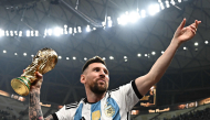 Argentina's captain and forward #10 Lionel Messi pose with the FIFA World Cup Trophy after Argentina won the Qatar 2022 World Cup final football match between Argentina and France at Lusail Stadium in Lusail, north of Doha on December 18, 2022. Photo by Anne-Christine POUJOULAT / AFP