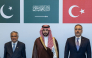 This handout photograph taken and released by the Turkish Foreign Ministry on October 5, 2026 shows (L-R) Pakistan's Deputy Prime Minister and Minister for Foreign Affairs Ishaq Dar, Saudi Defence Minister Prince Khalid bin Salman Al Saud and Turkish Foreign Minister Hakan Fidan posing during a meeting of the Strategic Political and Defense Committee, established under the Mecca Joint Defense Agreement, in Riyadh. (Photo by Handout / Turkish Foreign Ministry / AFP)