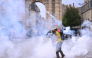Protesters stand amid tear gas fired by police during demonstration part of a nationwide day of actions called by high-school students in Bordeaux, southwestern France, on October 6, 2026. (Photo by Christophe ARCHAMBAULT / AFP)
