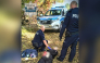 This handout picture taken and released by Policja Mazowsze on October 7, 2026, shows two policemen detaining a suspected high school knife attacker in the town of Ostroleka, some 130 km north of Warsaw. Photo by Handout / Policja Mazowsze / AFP
