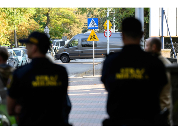 Police officers guard outside the scene of a knife attack at a vocational school in the town of Ostroleka, Poland. (Photo by Mladen ANTONOV / AFP)