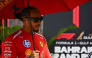 Ferrari's British driver Lewis Hamilton arrives ahead of the Formula One Bahrain Grand Prix in Sepang on October 4, 2026. (Photo by Lillian SUWANRUMPHA / AFP)
