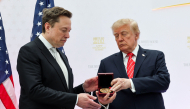 Tesla and SpaceX CEO Elon Musk (L) receives the National Medal of Science from U.S. President Donald Trump during the Golden Age of American Innovation Summit at the Institute of Peace on October 08, 2026 in Washington, DC. Photo by WIN MCNAMEE / GETTY IMAGES NORTH AMERICA / Getty Images via AFP