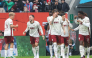 Augsburg's German midfielder #19 Robin Fellhauer (hidden) celebrates scoring the opening goal with his teammates during the German first division Bundesliga football match. (Photo by Karl-Josef HILDENBRAND / AFP) 