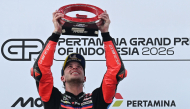 Aprilia Racing Italian rider Marco Bezzecchi celebrates on the podium after winning the MotoGP Indonesian Grand Prix at the Mandalika International Circuit in Mandalika on October 11, 2026. (Photo by SONNY TUMBELAKA / AFP)