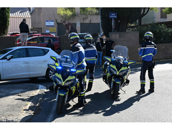 French gendarmes stand in front of Joseph-Lakanal high school after a headmaster was injured by a hunting rifle shot and a teenager was arrested in Aubagne, southern France, on October 12, 2026. (Photo by Miguel MEDINA / AFP)
