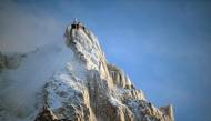 (Files) This photograph shows L'aiguille du Midi of the Massif du Mont-Blanc mountain range in the French Alps in France, on February 11, 2026. (Photo by Olivier Chassignole / AFP)