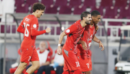 Al Duhail's Sekou Oumar Yansane (right) celebrates with teammates.