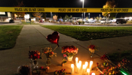 Candles and flowers are seen at a makeshift memorial outside the Silver Rail Elementary School following a shooting in Bend, Oregon, on October 15, 2026. Photo by Payton Bruni / AFP