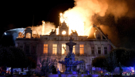 This photograph shows a fire burning and destroying the city hall after a group of individuals forced entry into the building in Limoges, central France on October 17, 2026. (Photo by Pascal Lachenaud / AFP)