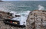 (Files) This photograph taken on January 10, 2024, shows an inflatable dinghy washed up on the rocky shores of Agios Georgios, east of the Greek island of Lesbos in the Aegean Sea. (Photo by Manolis Lagoutaris / AFP)