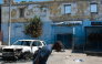 Man leaving prison area while lowering his head due to nearby gunfire in Port-au-Prince, Haiti. AFP file photo.
