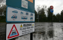 A flood warning sign is seen beside the River Eden in Carlisle in north-west England on October 25, 2026, as Storm Boelo brings strong winds and heavy rain across much of northern England. (Photo by Andy Buchanan / AFP)