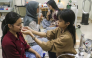 A volunteer (R) assists a woman with a nasal oxygen cannula at a shelter to aid residents experiencing respiratory difficulties in Palangkaraya, Central Kalimantan province on October 26, 2026. Photo by REINA / AFP