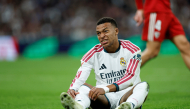 Real Madrid's French forward #10 Kylian Mbappe reacts on the ground during the Spanish league football match between Real Madrid CF and Sevilla FC at the Santiago Bernabeu stadium in Madrid on October 18, 2026.(Photo by Oscar DEL POZO / AFP)