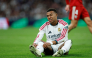 Real Madrid's French forward #10 Kylian Mbappe reacts on the ground during the Spanish league football match between Real Madrid CF and Sevilla FC at the Santiago Bernabeu stadium in Madrid on October 18, 2026.(Photo by Oscar DEL POZO / AFP)
