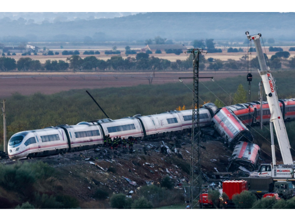 Investigators survey debris amongst the damaged carriages of a train crash between two high-speed units, a Renfe AVE train and an Iryo train around 150 km south of Madrid between Urda and Los Yebenes in the province of Toledo, a day after the accident on October 29, 2026. Photo by OSCAR DEL POZO / AFP
