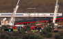 Huge cranes are employed to remove wrecked carriages of a train crash between a Renfe AVE train and an Iryo train, one day after the deadly accident in Urda, in the province of Toledo on October 29, 2026. Photo by OSCAR DEL POZO / AFP