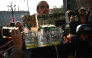 A protester holds a mirror to Guardia di Finanza officers during a demonstration part of a nationwide day of strikes and protests as school and university students demand more funding for schools and support for housing, in Turin on October 30, 2026. Photo by Marco BERTORELLO / AFP