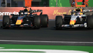 Red Bull Racing's Dutch driver Max Verstappen (L) and Racing Bulls' New Zealand driver Liam Lawson race in Mexico City on October 30, 2026. (Photo by Yuri Cortez / AFP)