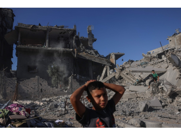 Palestinian boys stand amid the rubble after a building was hit overnight by an Israeli strike west of Jabalia in the northern Gaza Strip, on October 30, 2026. (Photo by Bashar Taleb / AFP)
