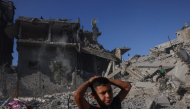 Palestinian boys stand amid the rubble after a building was hit overnight by an Israeli strike west of Jabalia in the northern Gaza Strip, on October 30, 2026. (Photo by Bashar Taleb / AFP)
