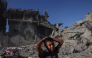Palestinian boys stand amid the rubble after a building was hit overnight by an Israeli strike west of Jabalia in the northern Gaza Strip, on October 30, 2026. (Photo by Bashar Taleb / AFP)
