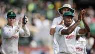 South Africa's Kagiso Rabada (R) and his teammates acknowledge the crowd after winning the match. (Photo by Marco Longari / AFP) 