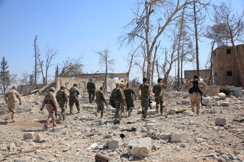 Forces loyal to Syria's President Bashar al-Assad walk at a military complex, after they recaptured areas in southwestern Aleppo that rebels had seized last month, Syria, in this handout picture provided by SANA on September 5, 2016. SANA