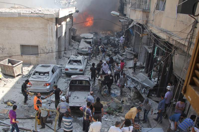 Syrians search for victims at the scene of a reported air strike on the rebel-held northwestern city of Idlib on September 10, 2016.  AFP / Omar haj kadour