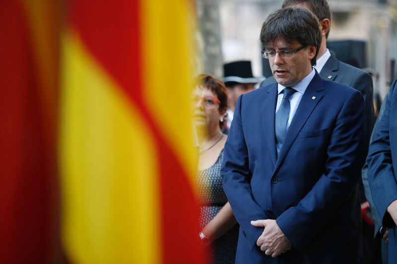 President of the Catalan regional Government Carles Puigdemont sings the official national anthem during a wreath-laying ceremony at the Rafael de Casanovas monument in Barcelona on September 11, 2016, on the day of the National Day of Catalonia 
