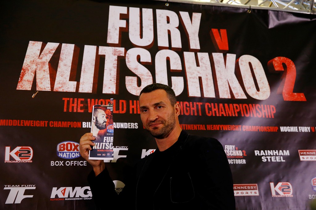 Wladimir Klitschko goes head to head with an image of Tyson Fury during the press conference. (Reuters / Peter Cziborra) 