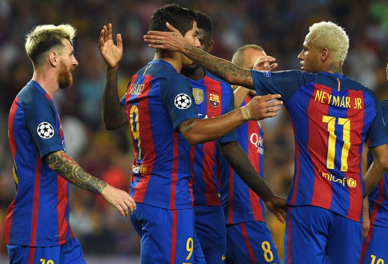 Barcelona's Uruguayan forward Luis Suarez (C) is congratulated by Barcelona's Brazilian forward Neymar (R) and Barcelona's Argentinian forward Lionel Messi (L) after scoring a goal during the UEFA Champions League football match FC Barcelona vs Celtic FC 