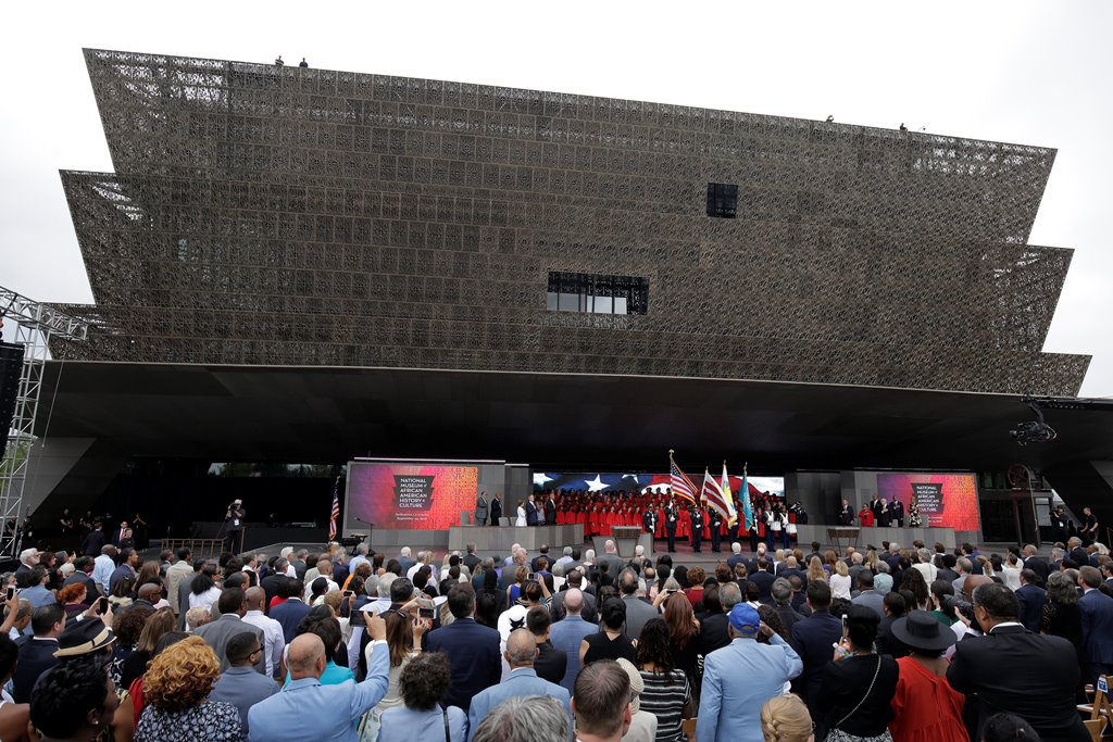 People stand during the dedication of the National Museum of African American History and Culture in Washington, U.S., September 24, 2016. Reuters/Joshua Roberts