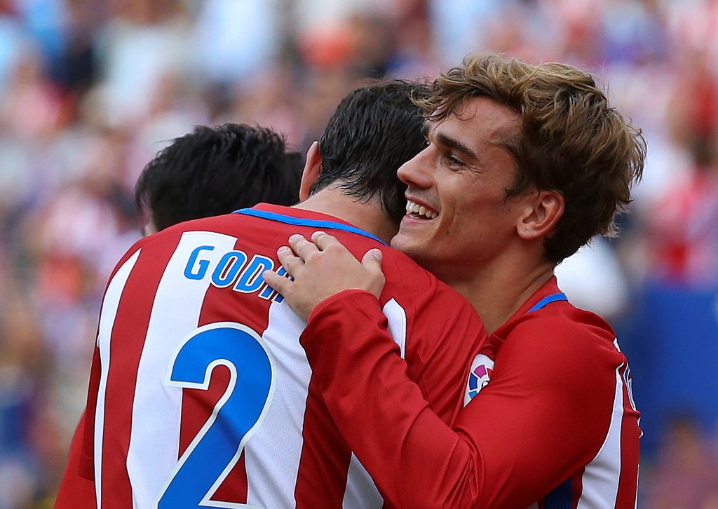 Atletico Madrid's Antoine Griezmann (R) celebrates his goal with teammate Diego Godin. REUTERS/Andrea Comas