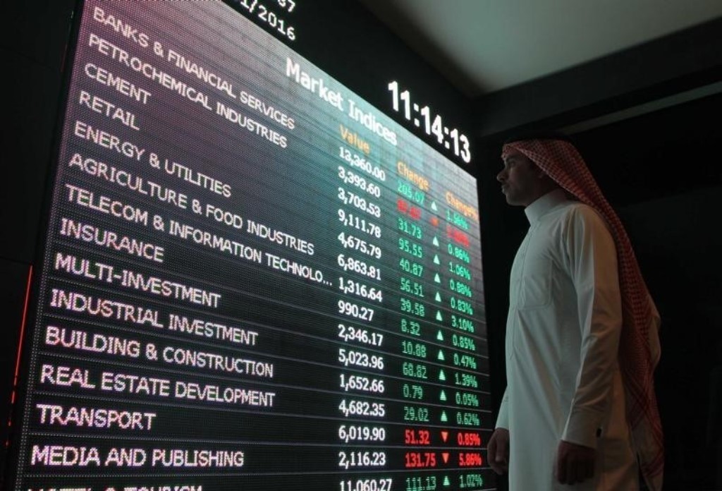 File photo of an investor monitoring a screen displaying stock information at the Saudi Stock Exchange (Tadawul) in Riyadh, Saudi Arabia. Faisal Nasser / Reuters.