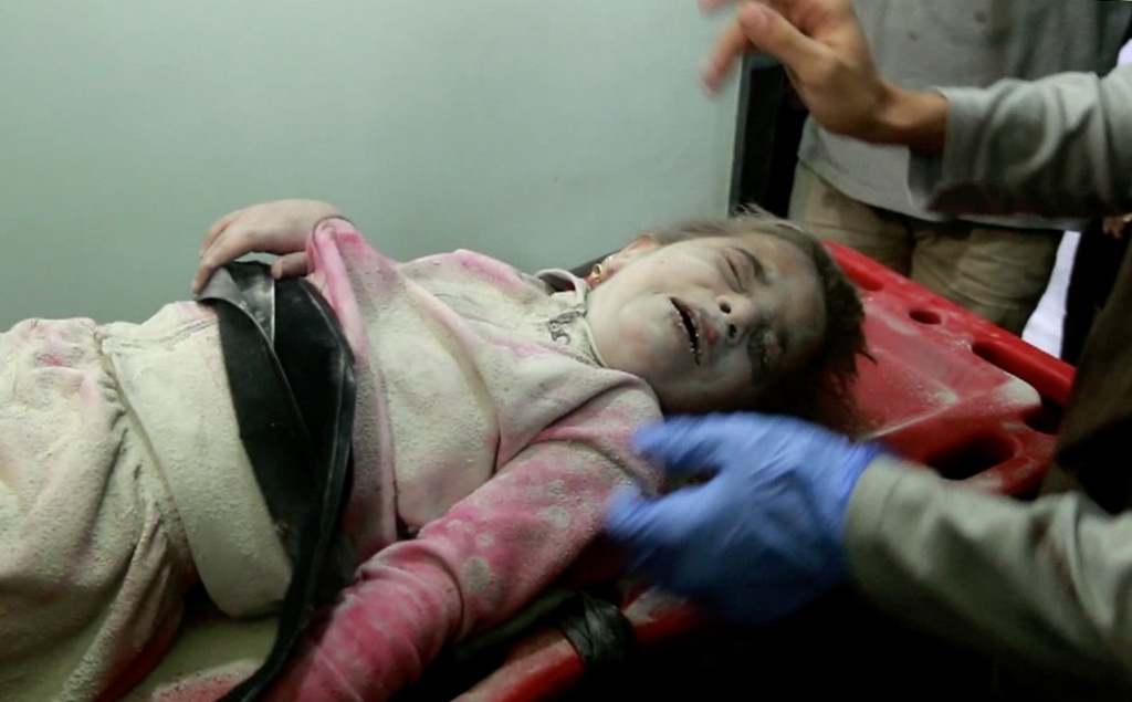  This photo captured from a video shows that injured Sabah Sheikh Qasim, one of 6-year-old Syrian twin sisters, is being taken to hospital after she was pulled out from the wreckage of a five-storey building hit by Assad regime forces' air strikes in Shaa