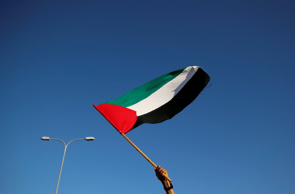 An Israeli Arab carries a Palestinian flag during a march in the northern town of Sakhnin October 1, 2016 marking the anniversary of the October 2000 Palestinian uprising. REUTERS/Ammar Awad
