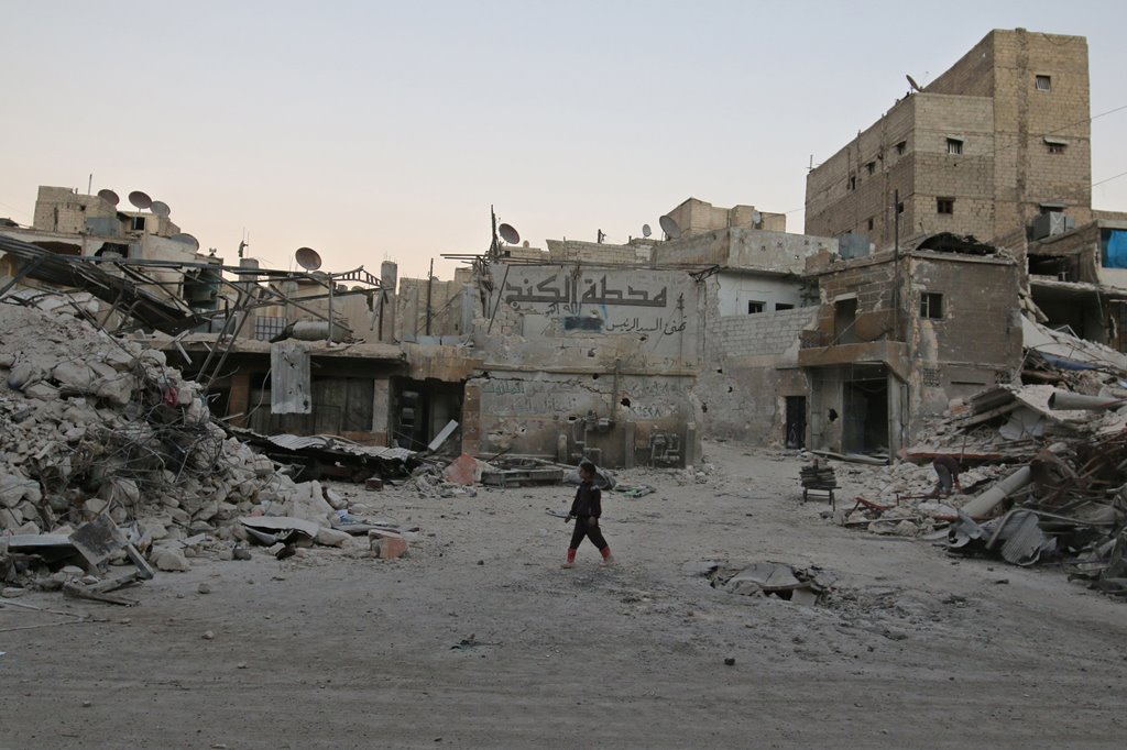 A boy walks amid damaged buildings in the rebel held area of al-Kalaseh neighbourhood of Aleppo, Syria, September 29, 2016. (Abdalrhman Ismail/Reuters)