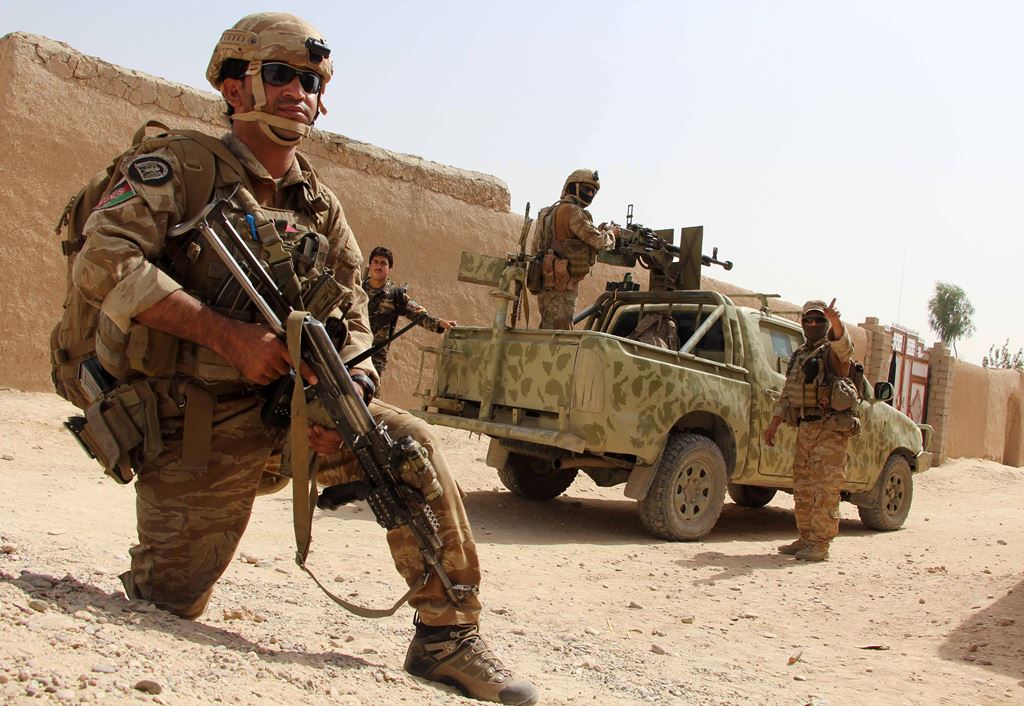 In this photograph taken on October 2, 2016, Afghan National Army commandos take position during a military operation in Helmand province. AFP / NOOR MOHAMMAD