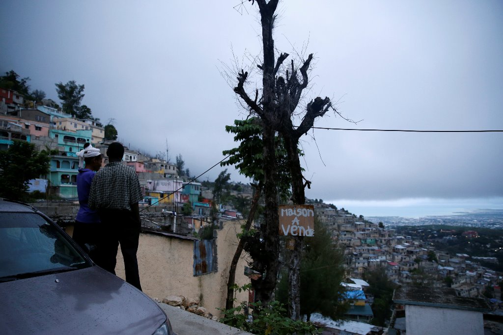 A couple enjoy the view while Hurricane Matthew approaches Port-au-Prince, Haiti, October 3, 2016. The text reads, 
